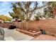 Spacious backyard featuring patio furniture, a brick wall, and well-maintained landscaping at 971 Whispering Grove Ave, Las Vegas, NV 89123