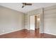 Bedroom with hardwood floors, ceiling fan and built-in shelving at 971 Whispering Grove Ave, Las Vegas, NV 89123