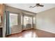 Bright bedroom with hardwood floors, multiple windows and ceiling fan at 971 Whispering Grove Ave, Las Vegas, NV 89123
