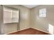 Bedroom featuring wood flooring and window with blinds at 971 Whispering Grove Ave, Las Vegas, NV 89123