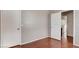 A calm bedroom featuring hardwood flooring and a doorway to the bathroom at 971 Whispering Grove Ave, Las Vegas, NV 89123
