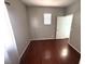 Bedroom with hardwood floors, neutral paint, a window, and a door to another room at 971 Whispering Grove Ave, Las Vegas, NV 89123