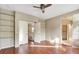 Bedroom with hardwood floors, ceiling fan, closet, and built-in shelving at 971 Whispering Grove Ave, Las Vegas, NV 89123