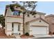 Two-story home with a two car garage, red tile roof, and desert landscaping at 971 Whispering Grove Ave, Las Vegas, NV 89123