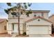 Two-story home with a two car garage and red tile roof at 971 Whispering Grove Ave, Las Vegas, NV 89123