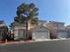 Charming two-story home features a well-manicured front yard and attached two-car garage at 971 Whispering Grove Ave, Las Vegas, NV 89123