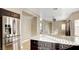 Open-concept kitchen features stainless steel appliances, dark cabinets, and an island with white countertop at 971 Whispering Grove Ave, Las Vegas, NV 89123