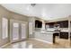 Modern kitchen featuring dark cabinets, stainless steel appliances, and elegant countertops at 971 Whispering Grove Ave, Las Vegas, NV 89123