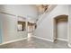 Open concept living room with tile flooring, a staircase, and neutral paint at 971 Whispering Grove Ave, Las Vegas, NV 89123