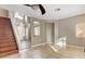 Living room with tile flooring, a staircase, and natural light at 971 Whispering Grove Ave, Las Vegas, NV 89123
