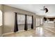Open concept living room with tile flooring, a ceiling fan, and access to kitchen at 971 Whispering Grove Ave, Las Vegas, NV 89123