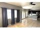 Open-concept living area with large windows, tile floors, and seamless connection to the kitchen at 971 Whispering Grove Ave, Las Vegas, NV 89123