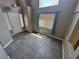 Bright entryway with grey tile flooring, large windows, and views of the front yard at 971 Whispering Grove Ave, Las Vegas, NV 89123