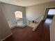 Hardwood staircase with white railings, featuring a window with natural light, leading to the rooms at 971 Whispering Grove Ave, Las Vegas, NV 89123