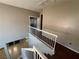 Carpeted stairs with white railings, leading to the second floor with hardwood floors at 971 Whispering Grove Ave, Las Vegas, NV 89123