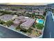 Aerial view of a beautiful home with private pool, landscaping, and desert surroundings at 9760 Arch Canyon Ct, Las Vegas, NV 89149