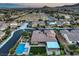Drone eye view of a community showcasing houses and their beautiful designed swimming pools and backyard areas at 9760 Arch Canyon Ct, Las Vegas, NV 89149
