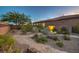 The well-maintained backyard is beautifully landscaped with desert foliage and rock ground cover at 9760 Arch Canyon Ct, Las Vegas, NV 89149