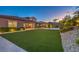 Expansive backyard features artificial grass, a covered patio, and professional landscaping at 9760 Arch Canyon Ct, Las Vegas, NV 89149