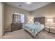 This bedroom features a light blue bedspread, carpet flooring, and natural lighting through the window at 9760 Arch Canyon Ct, Las Vegas, NV 89149