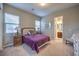 This carpeted bedroom features neutral paint colors, a window, and an ensuite bathroom at 9760 Arch Canyon Ct, Las Vegas, NV 89149