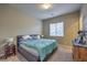 The bedroom has an angled ceiling, plush carpet, and a large window for natural light at 9760 Arch Canyon Ct, Las Vegas, NV 89149