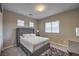 This bedroom has a gray, tufted headboard, and is illuminated by natural light from three windows at 9760 Arch Canyon Ct, Las Vegas, NV 89149