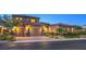 Beautiful two-story home with a three-car garage and meticulously landscaped front yard and a brick driveway at 9760 Arch Canyon Ct, Las Vegas, NV 89149