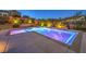 The backyard boasts a modern pool with colorful lighting, integrated spa, and patio at 9760 Arch Canyon Ct, Las Vegas, NV 89149