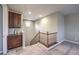 The stairway has wood banisters, neutral walls and carpet, and an attached dark wood cabinet at 9760 Arch Canyon Ct, Las Vegas, NV 89149