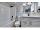 Bright bathroom with white vanity, shower-tub combo, and modern black hardware at 1013 Cunningham Dr, Las Vegas, NV 89106