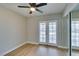 Bedroom features a ceiling fan and glass doors to the back at 1013 Cunningham Dr, Las Vegas, NV 89106