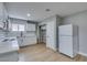 Cozy kitchen featuring white cabinetry, new appliances, and bright lighting at 1013 Cunningham Dr, Las Vegas, NV 89106