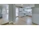 Bright, open kitchen with access to the living room, stainless steel appliances, and white cabinets at 1013 Cunningham Dr, Las Vegas, NV 89106