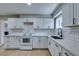 Bright kitchen features white cabinets, subway tile backsplash, and modern countertops at 1013 Cunningham Dr, Las Vegas, NV 89106