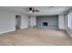 Open living room with a brick fireplace, wood-look floors, and ample natural light at 1013 Cunningham Dr, Las Vegas, NV 89106