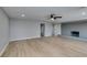 Open-concept living room featuring wood-look flooring, neutral paint, and ceiling fan at 1013 Cunningham Dr, Las Vegas, NV 89106