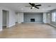 Bright living room with brick fireplace, ceiling fan, and light wood flooring at 1013 Cunningham Dr, Las Vegas, NV 89106