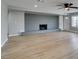 Spacious living room featuring a brick fireplace, ceiling fan, and light wood flooring at 1013 Cunningham Dr, Las Vegas, NV 89106