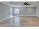 Open-concept living area with light wood floors, fresh gray walls, and abundant natural light at 1013 Cunningham Dr, Las Vegas, NV 89106