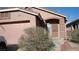 Charming single-story home with a stucco facade, arched entryway, and a well-manicured front yard at 10220 Arlington Abby St, Las Vegas, NV 89183