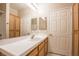 Bathroom with tiled floors, wooden vanity with a white countertop, and large mirrors over the sink at 1050 E Cactus Ave # 1128, Las Vegas, NV 89183