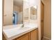 Bright bathroom features tiled floors, a wooden vanity with white countertops, and large mirrors over the sink at 1050 E Cactus Ave # 1128, Las Vegas, NV 89183