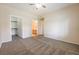 Large bedroom features neutral carpeting, light walls, a ceiling fan, plus closet and bathroom access at 1050 E Cactus Ave # 1128, Las Vegas, NV 89183