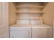 Laundry room featuring a side by side washer and dryer, as well as built in shelving above at 1050 E Cactus Ave # 1128, Las Vegas, NV 89183