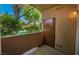 Relaxing outdoor patio and storage area featuring trees, bushes, and a small wall for privacy at 1050 E Cactus Ave # 1128, Las Vegas, NV 89183