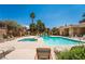 Community pool and spa, surrounded by lounge chairs and lush landscaping, perfect for relaxation and socializing at 1050 E Cactus Ave # 1128, Las Vegas, NV 89183