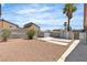 Spacious backyard with gravel landscaping, block wall, palm tree, and two sheds for extra storage at 1158 E Hacienda Ave, Las Vegas, NV 89119
