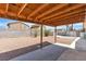 A spacious backyard features a covered patio, rock landscaping and privacy walls at 1158 E Hacienda Ave, Las Vegas, NV 89119