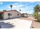 Back exterior view showing the concrete patio, gravel area, block wall, and mature landscaping at 1158 E Hacienda Ave, Las Vegas, NV 89119